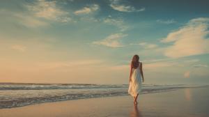 A Background Image of a Woman Walking on the Beach PowerPoint clipart graphic preview.